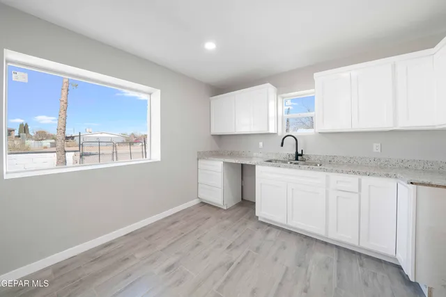 a kitchen with sink a window and appliances
