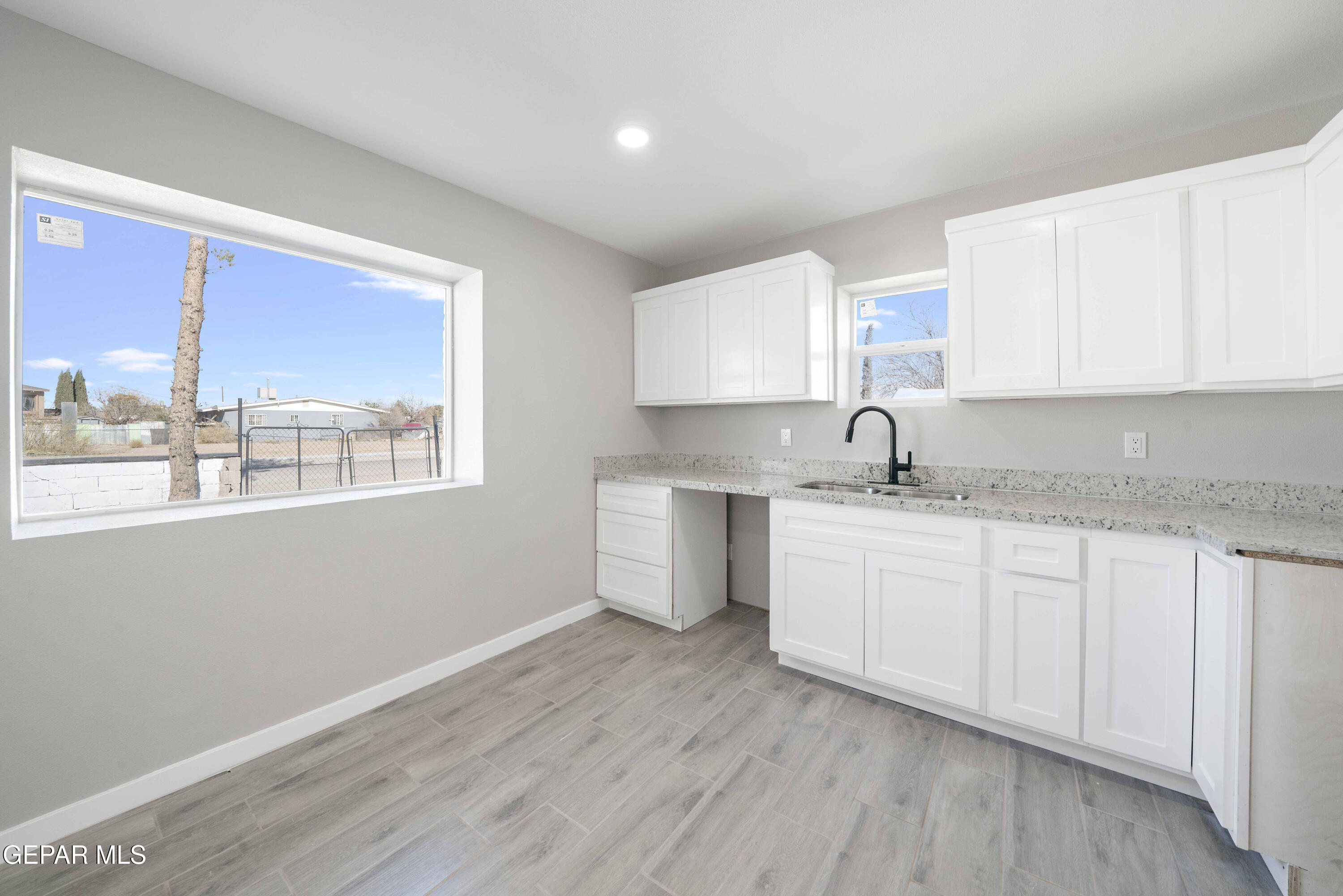 10752 Mellward Road Socorro, TX 79927 - Photo 19 of 37 a kitchen with sink a window and appliances