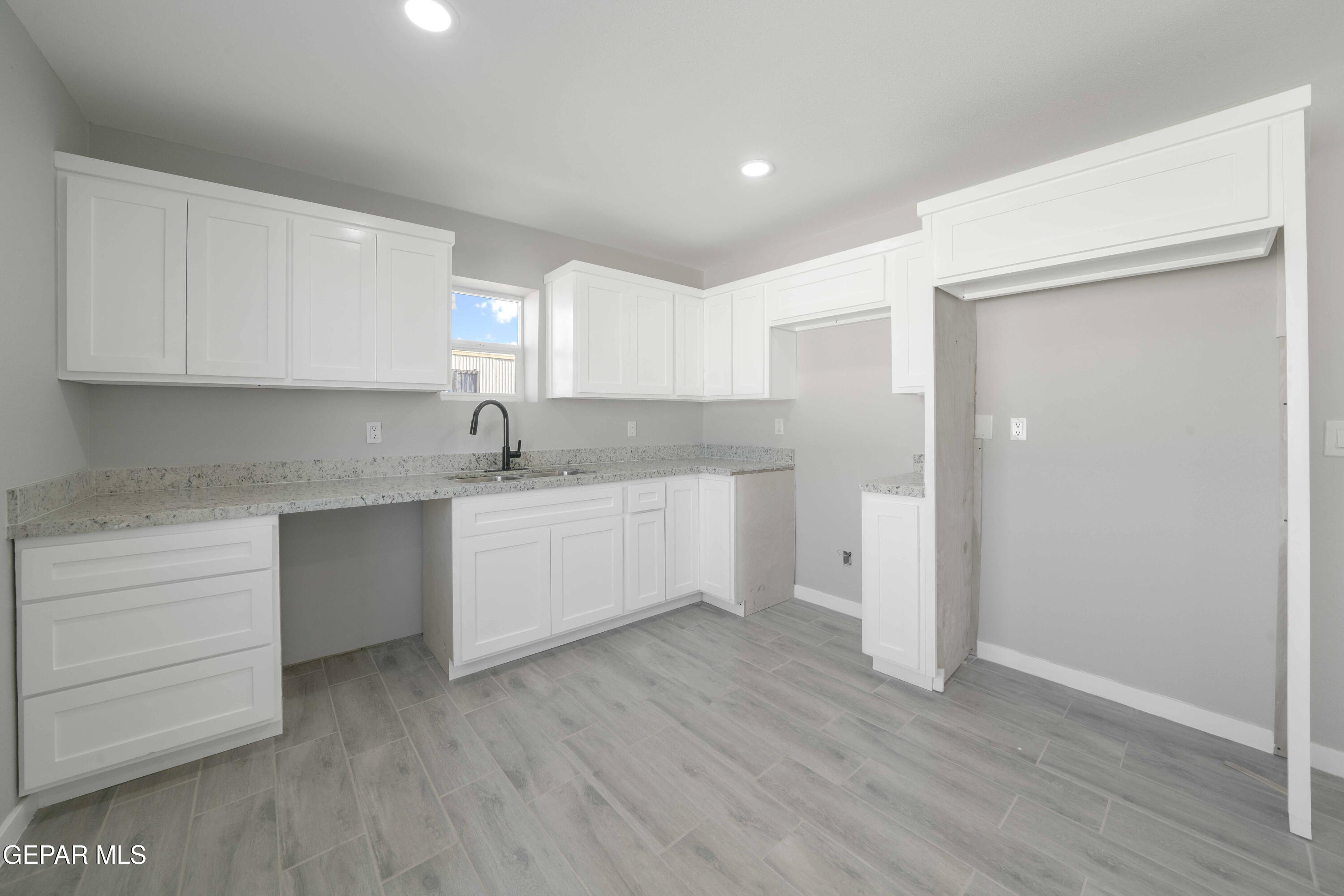 10752 Mellward Road Socorro, TX 79927 - Photo 23 of 37 a kitchen with a refrigerator sink and cabinets