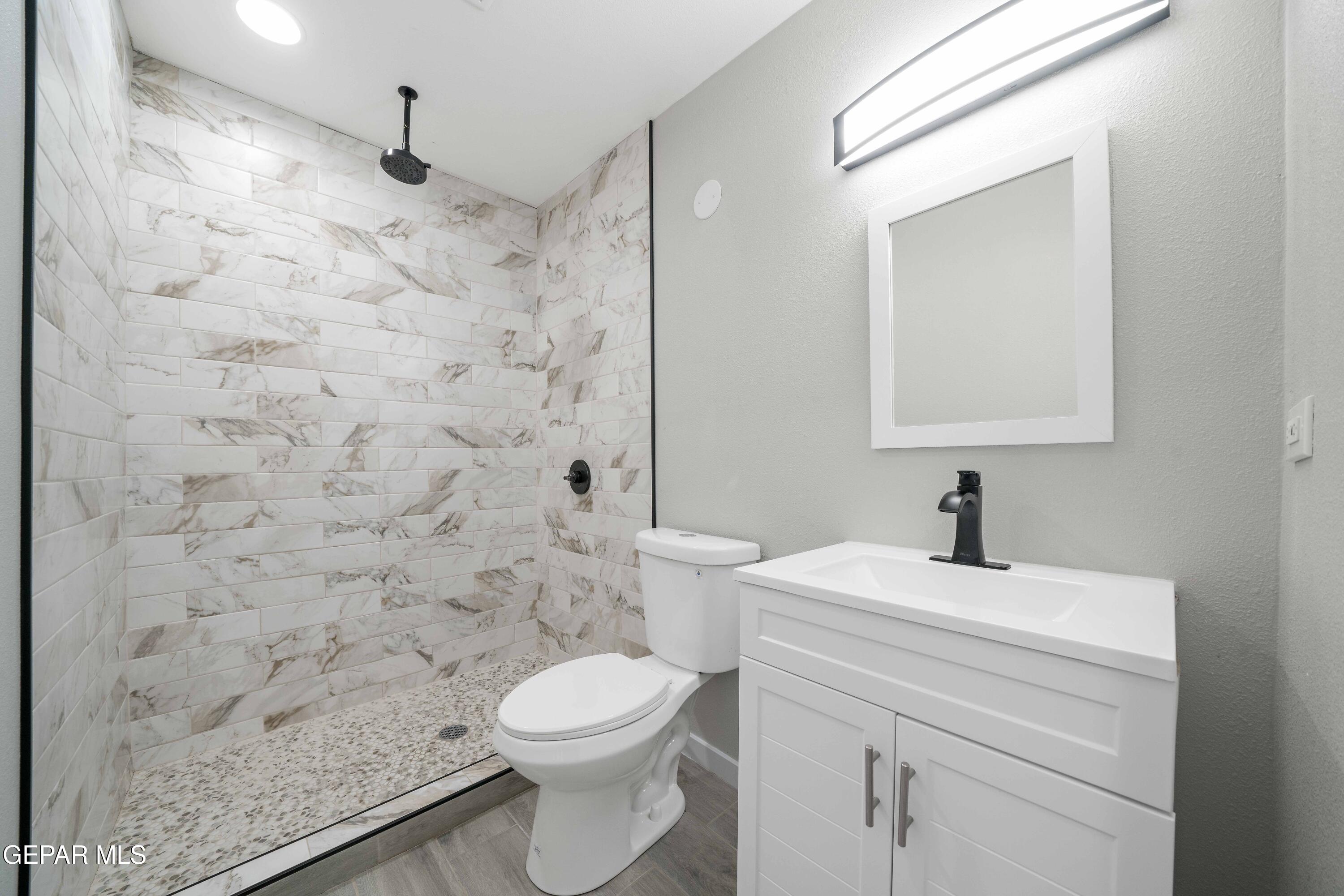 10752 Mellward Road Socorro, TX 79927 - Photo 26 of 37 a bathroom with a sink a toilet and a mirror