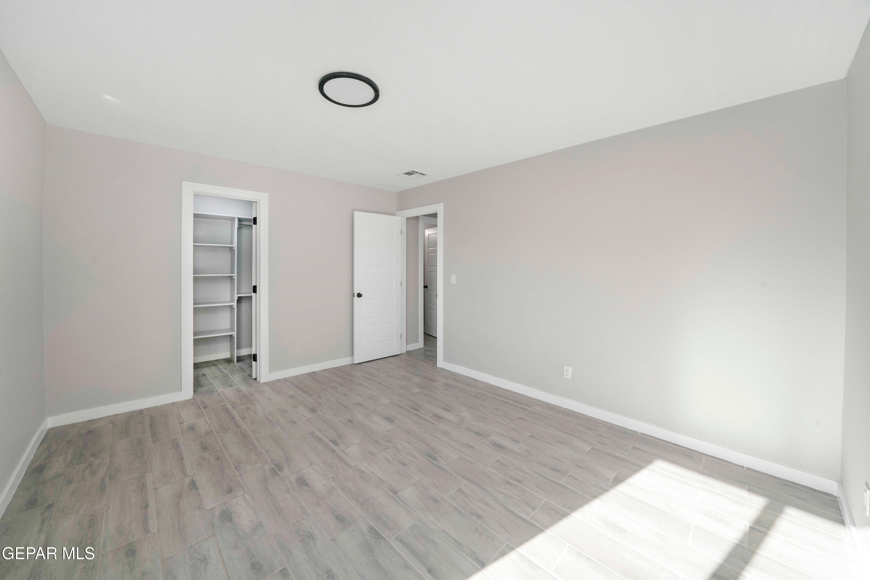 10752 Mellward Road Socorro, TX 79927 - Photo 27 of 37 a view of an empty room with wooden floor and a window