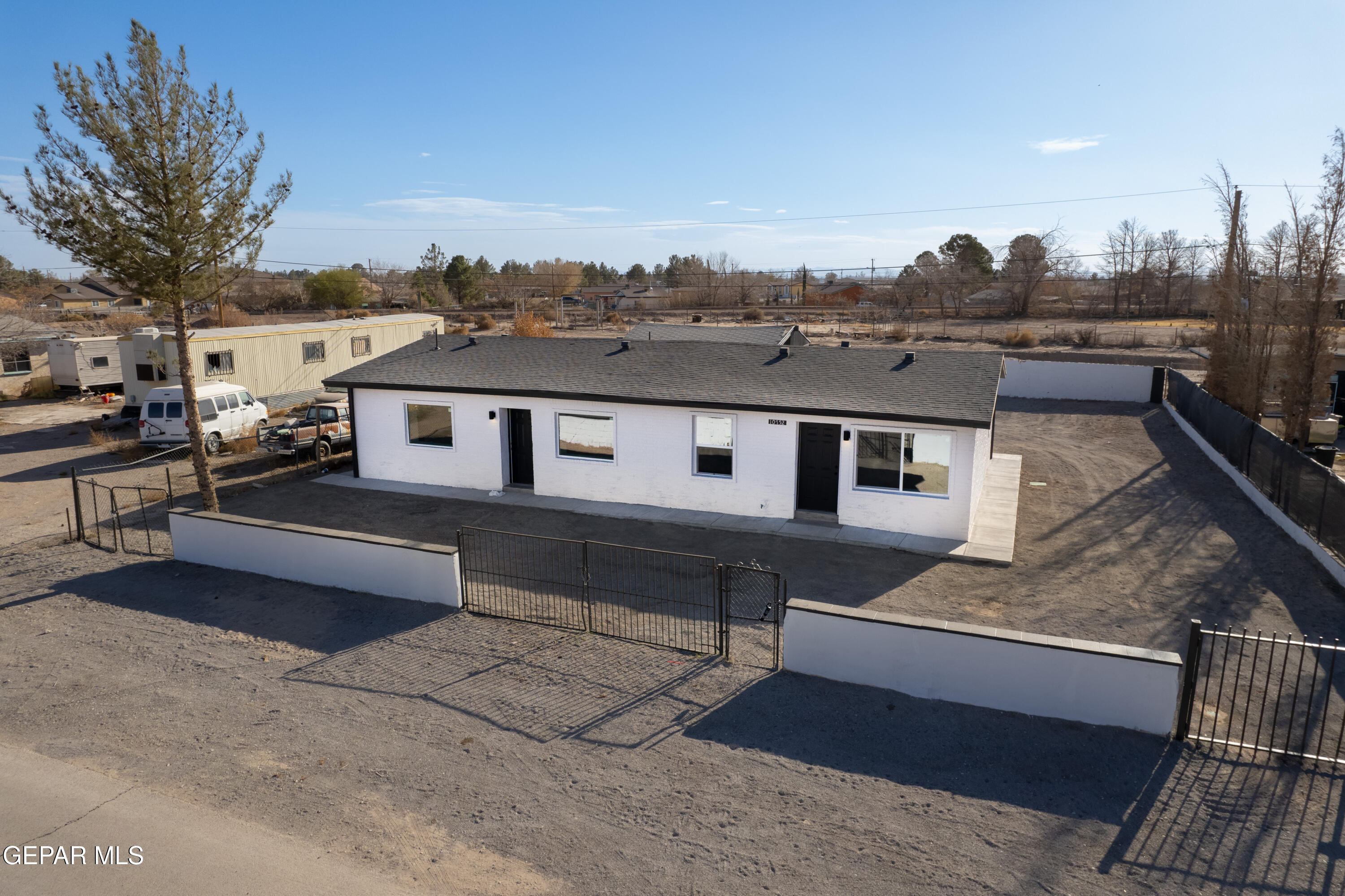 10752 Mellward Road Socorro, TX 79927 - Photo 3 of 37 a front view of a house with a yard