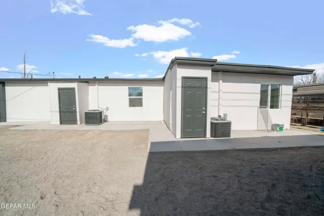 a view of a house with backyard and a kitchen