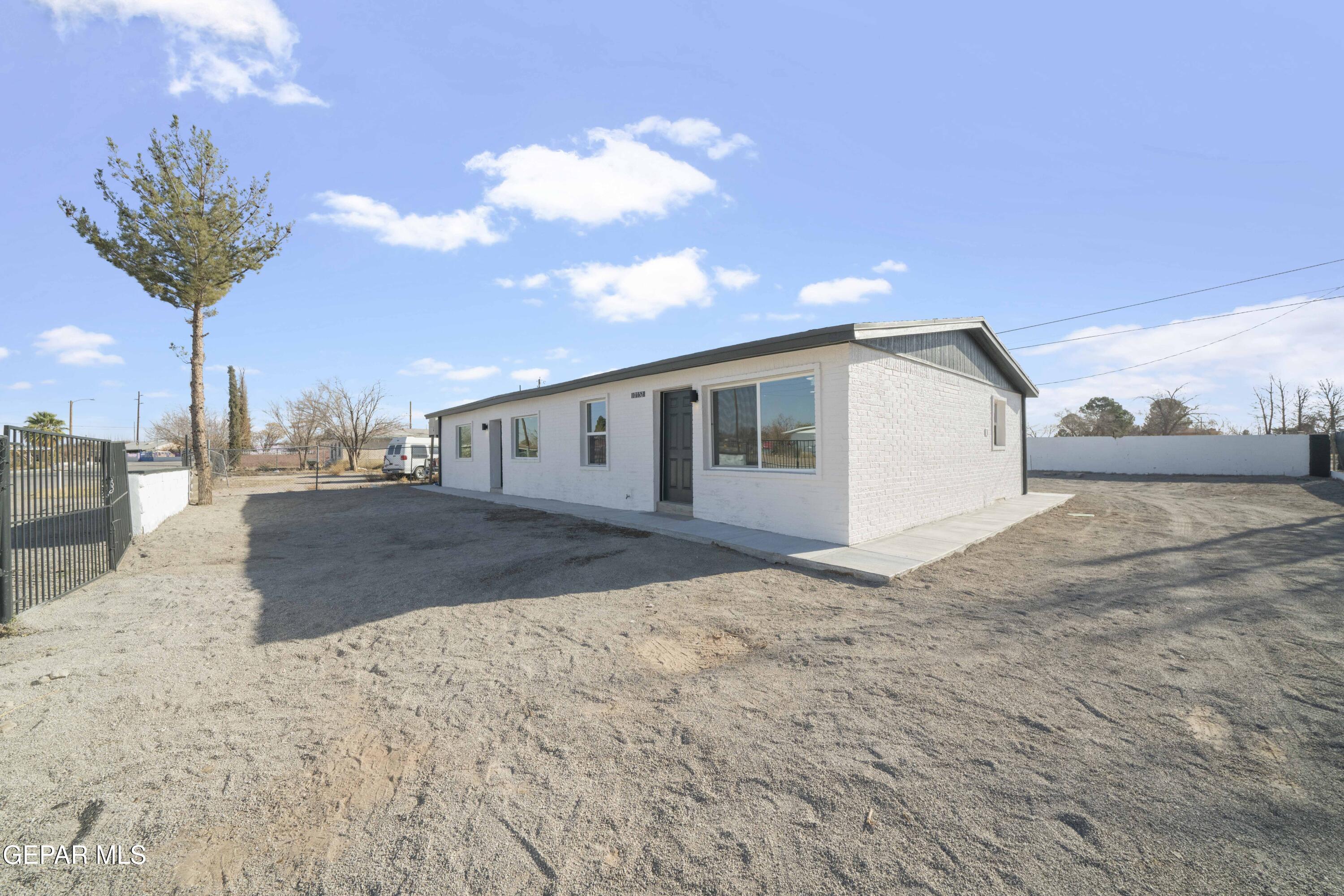 10752 Mellward Road Socorro, TX 79927 - Photo 34 of 37 a view of a house with a backyard