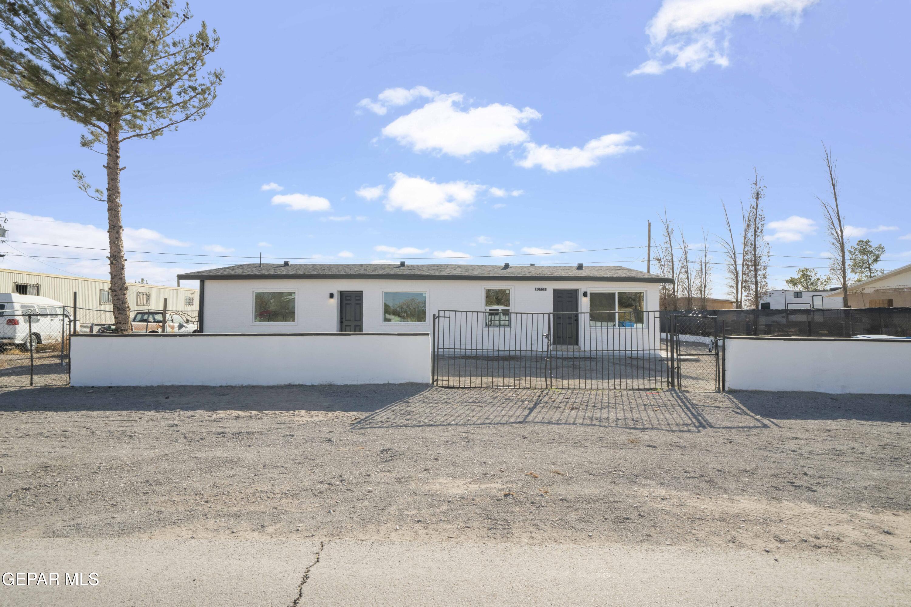 10752 Mellward Road Socorro, TX 79927 - Photo 35 of 37 a front view of a house with a yard and garage