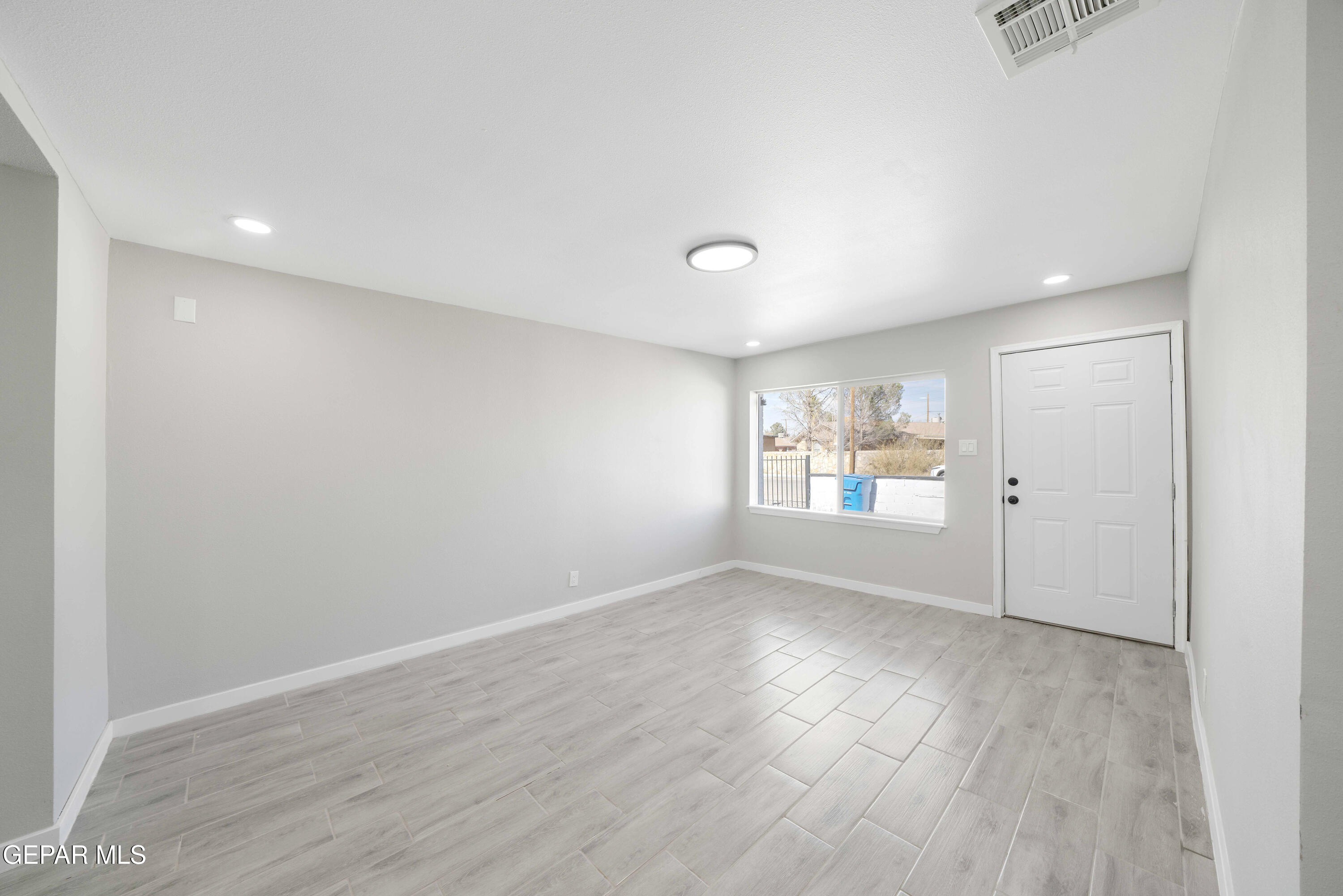 10752 Mellward Road Socorro, TX 79927 - Photo 6 of 37 wooden floor in an empty room with a window