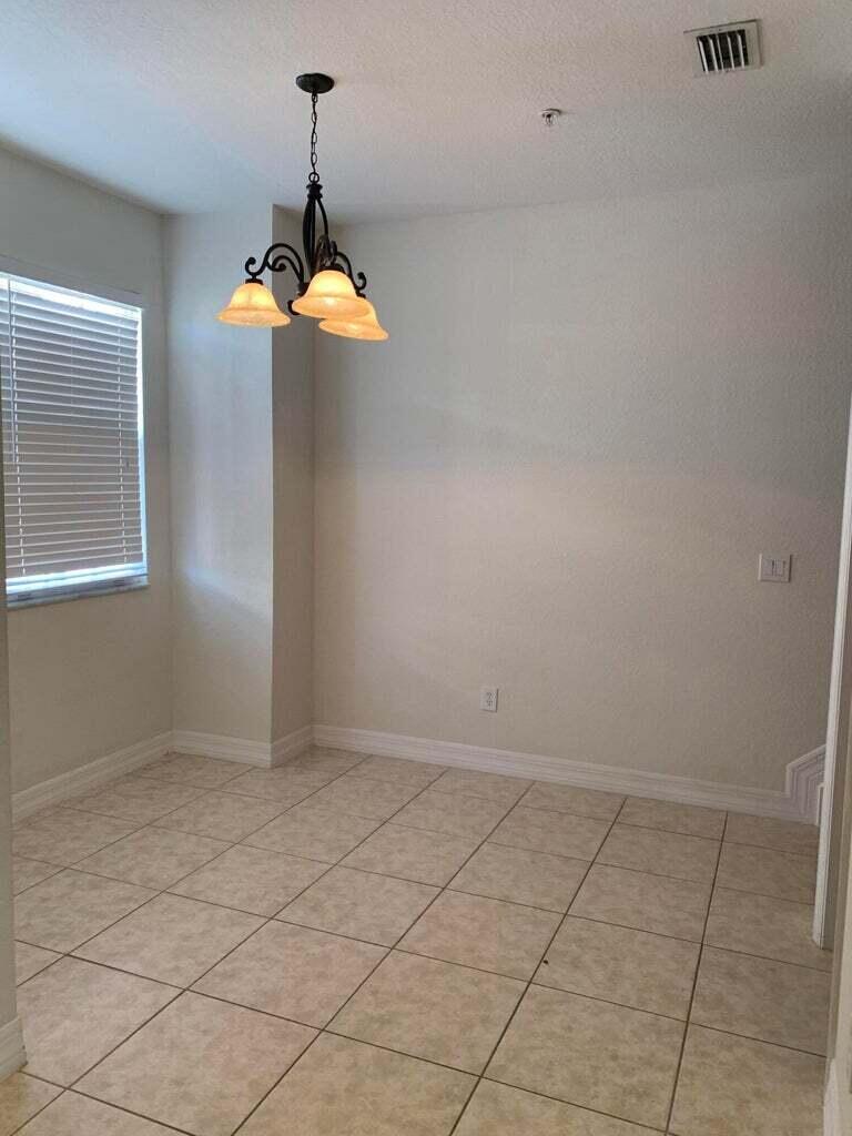 125 Harbors Way Boynton Beach, FL 33435 - Photo 11 of 37 an empty room with chandelier fan