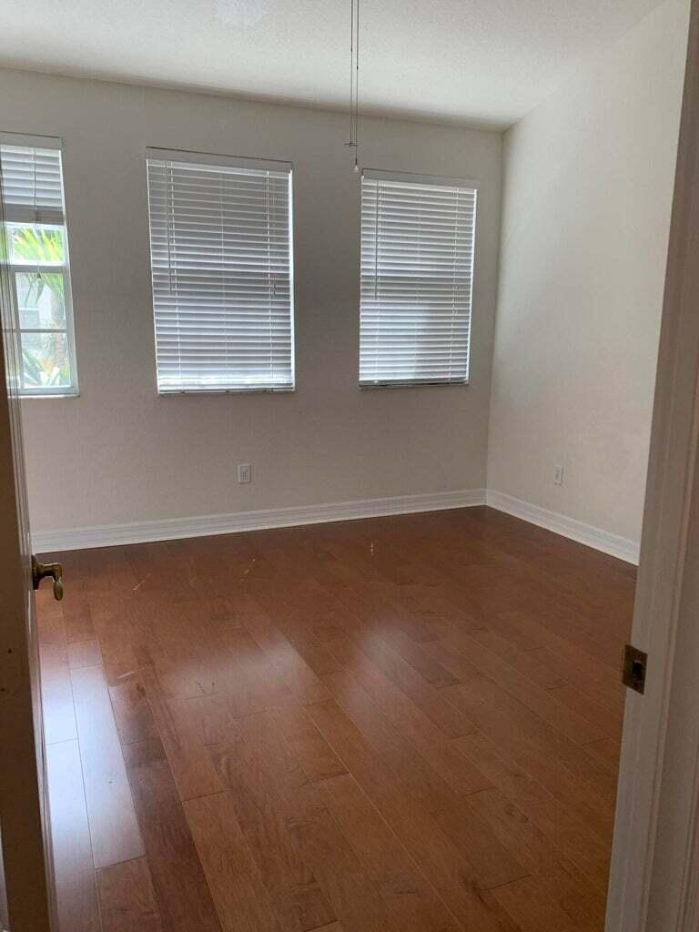 125 Harbors Way Boynton Beach, FL 33435 - Photo 15 of 37 an empty room with wooden floor and windows