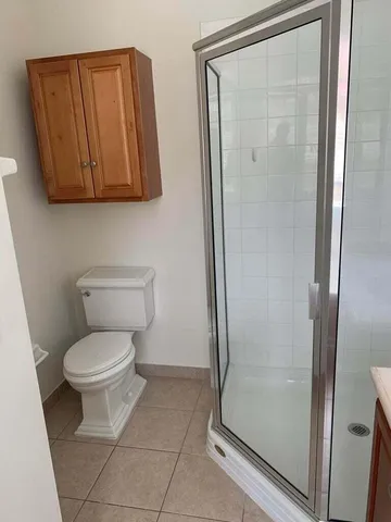 a bathroom with a toilet and a shower