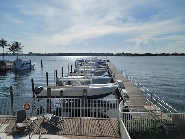 an outdoor sitting area with furniture and lake view