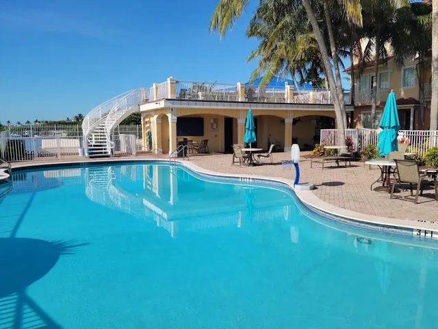a view of a swimming pool with outdoor seating