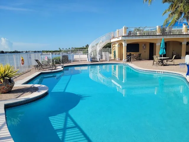 a view of a swimming pool with outdoor seating