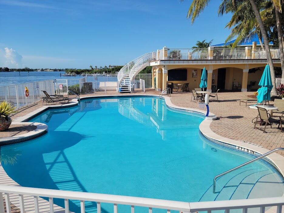125 Harbors Way Boynton Beach, FL 33435 - Photo 36 of 37 a view of a swimming pool with outdoor seating