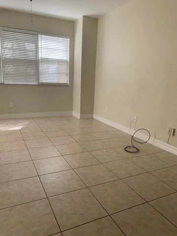 an empty room with a empty space and window