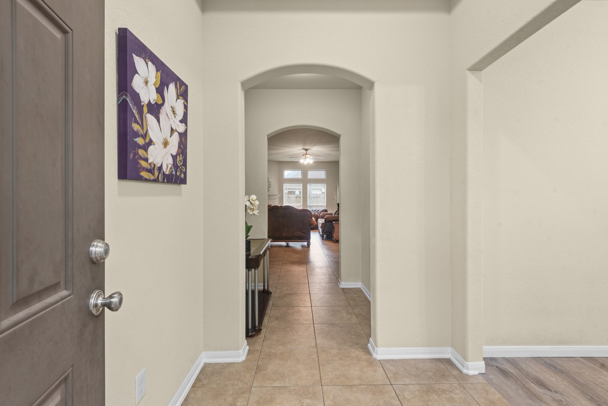 5211 Cayenne Lane Baytown, TX 77521 - Photo 2 of 19 Step inside to a welcoming entry with neutral paint and tile flowing through to the living room.