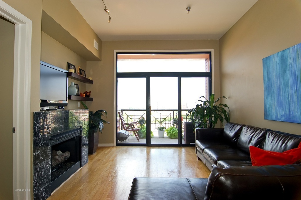 a living room with furniture fireplace and flat screen tv