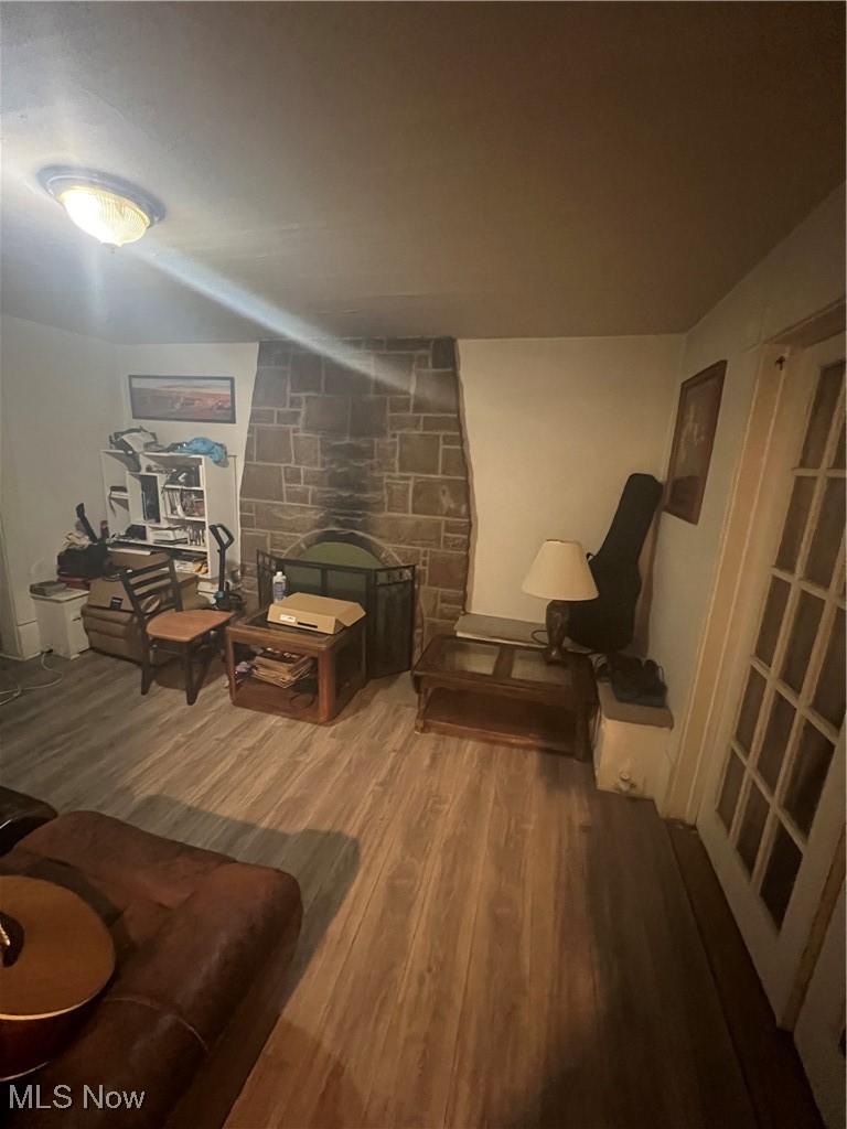 Living area with a fireplace and hardwood / wood-style floors