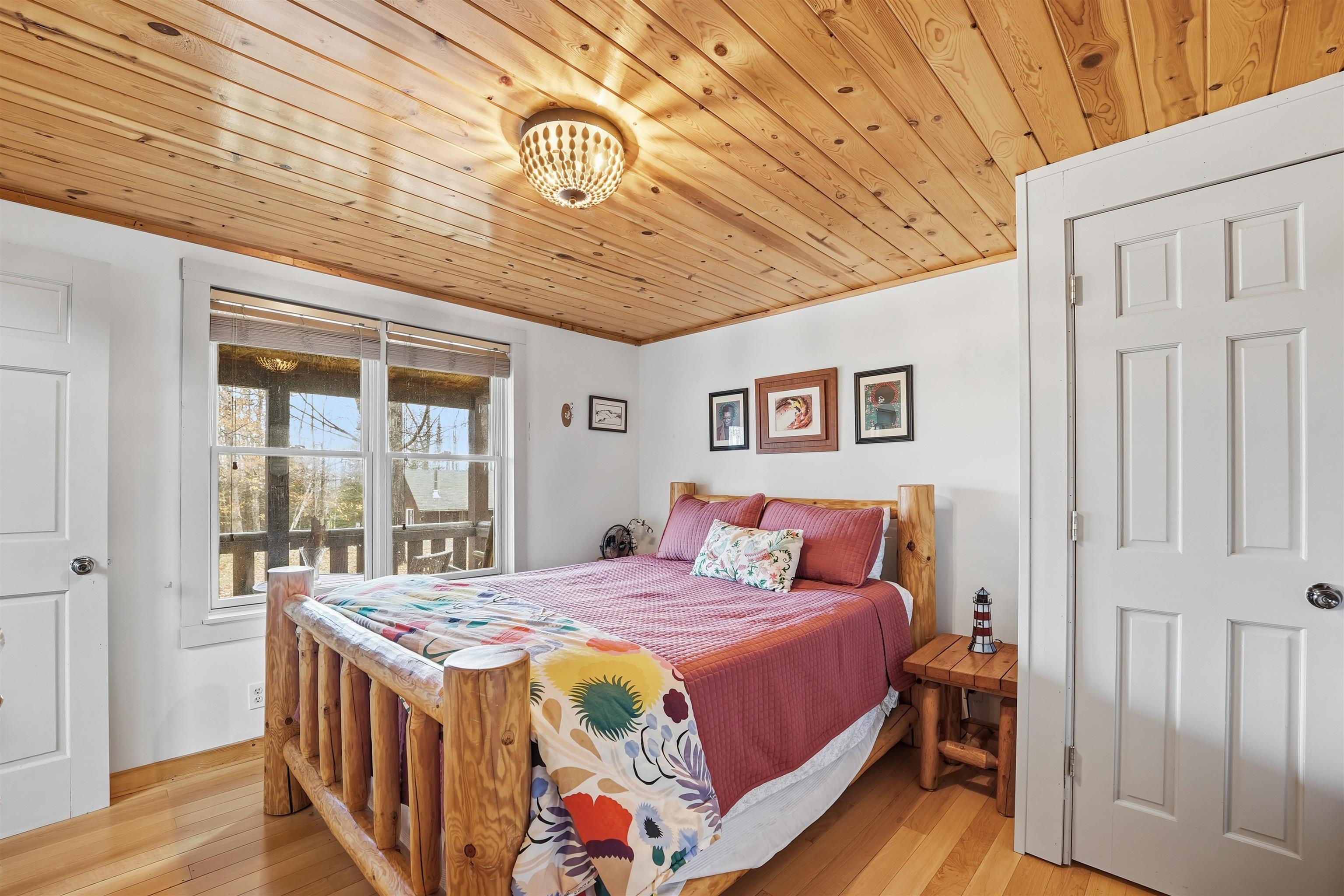 85255 Ravine Road Port Wing, WI 54865 - Photo 14 of 38 Bedroom with light wood-style floors and wooden ceiling
