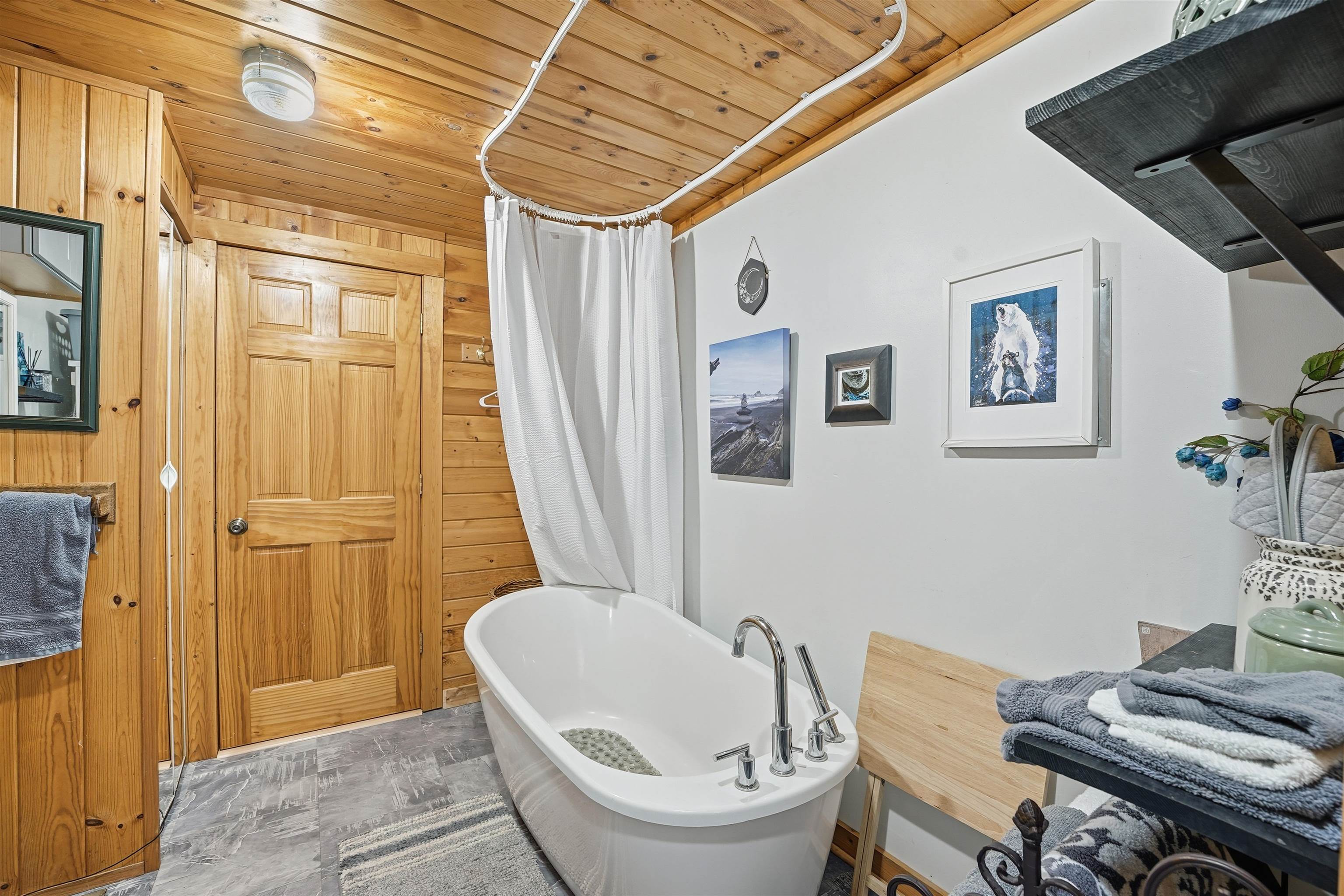 85255 Ravine Road Port Wing, WI 54865 - Photo 15 of 38 Full bath featuring a freestanding bath, wood ceiling, a shower with shower curtain, and wooden walls