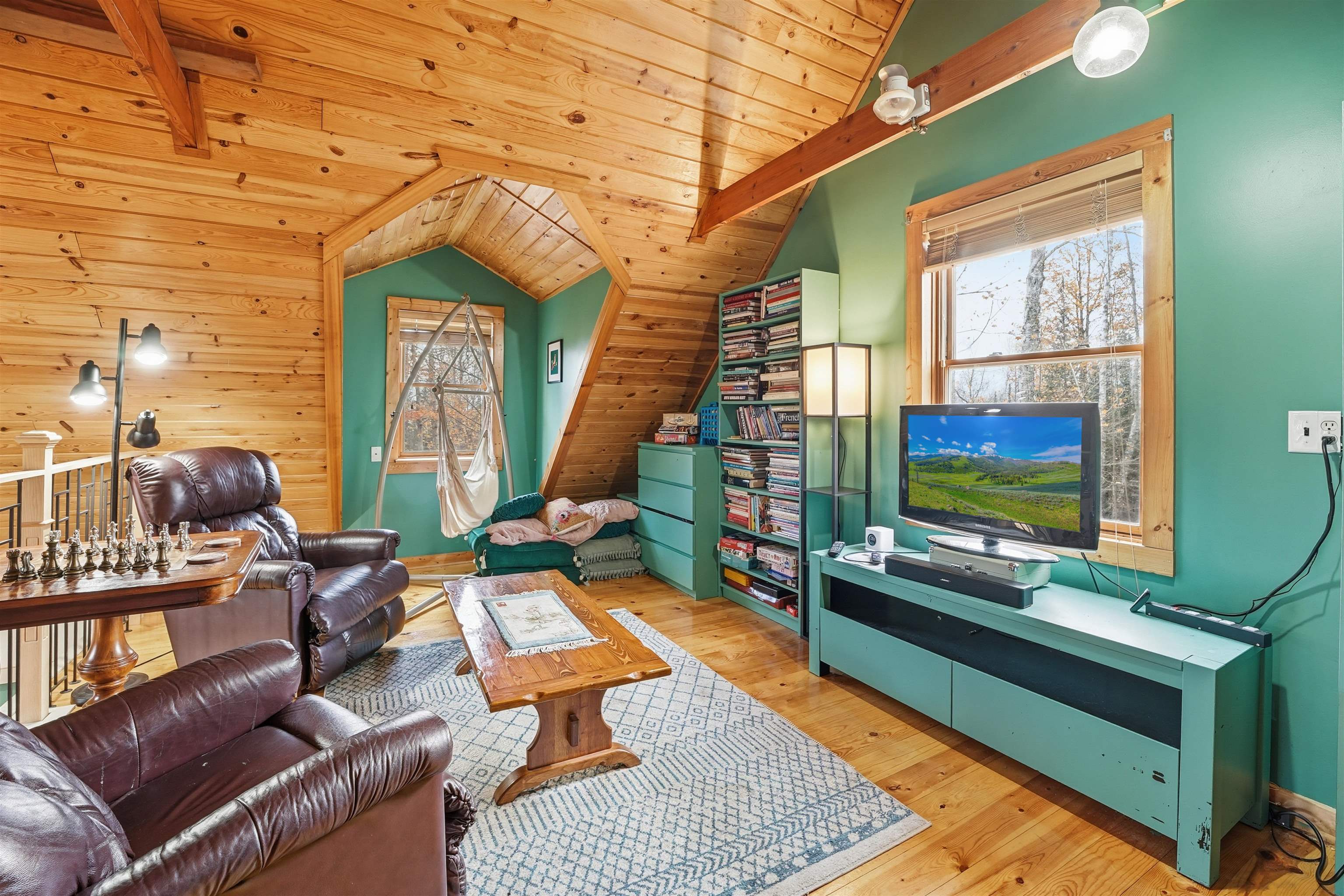 85255 Ravine Road Port Wing, WI 54865 - Photo 18 of 38 Living room featuring wood finished floors, wooden walls, wood ceiling, and plenty of natural light