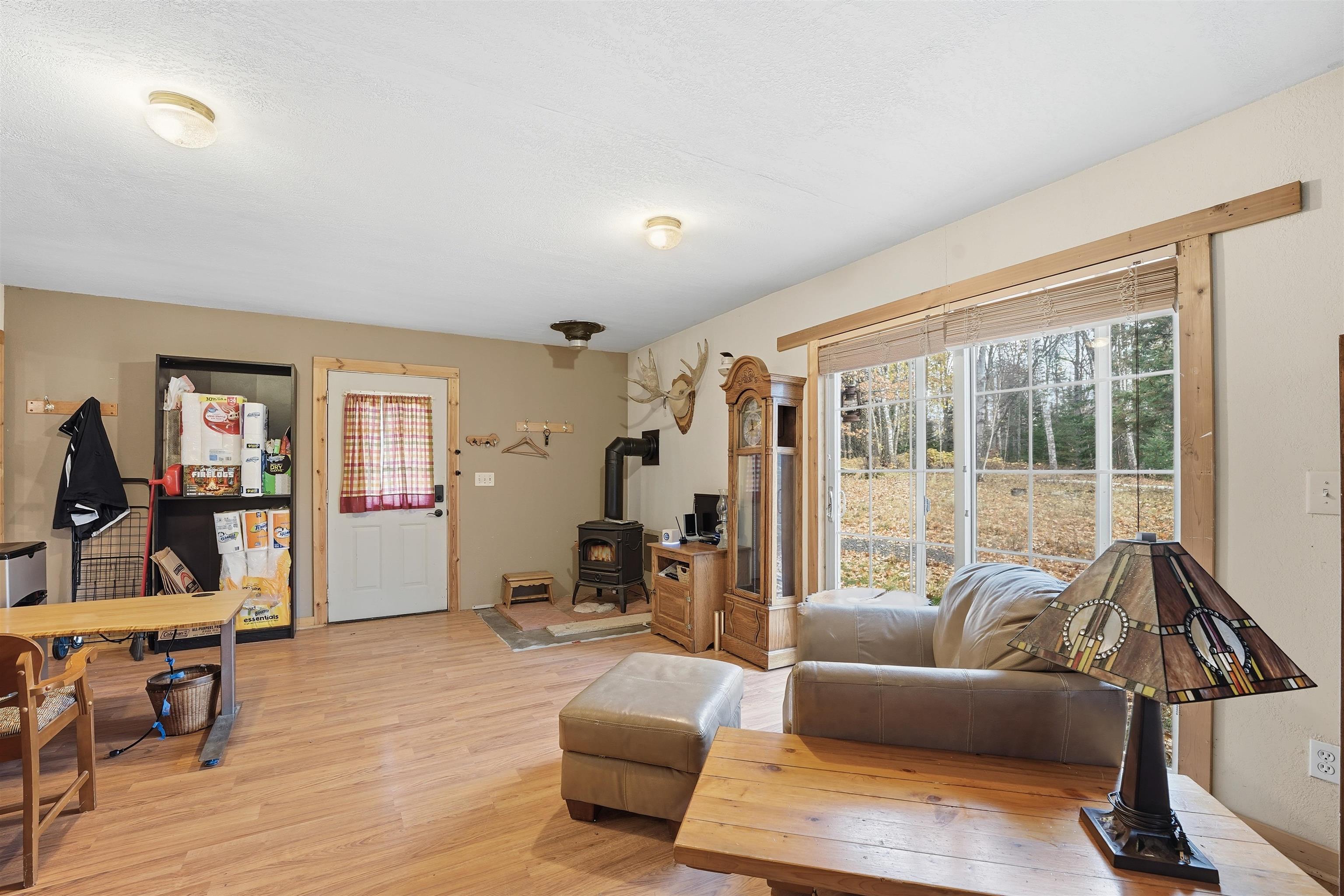 85255 Ravine Road Port Wing, WI 54865 - Photo 21 of 38 Living area with a wood stove and light wood-style floors