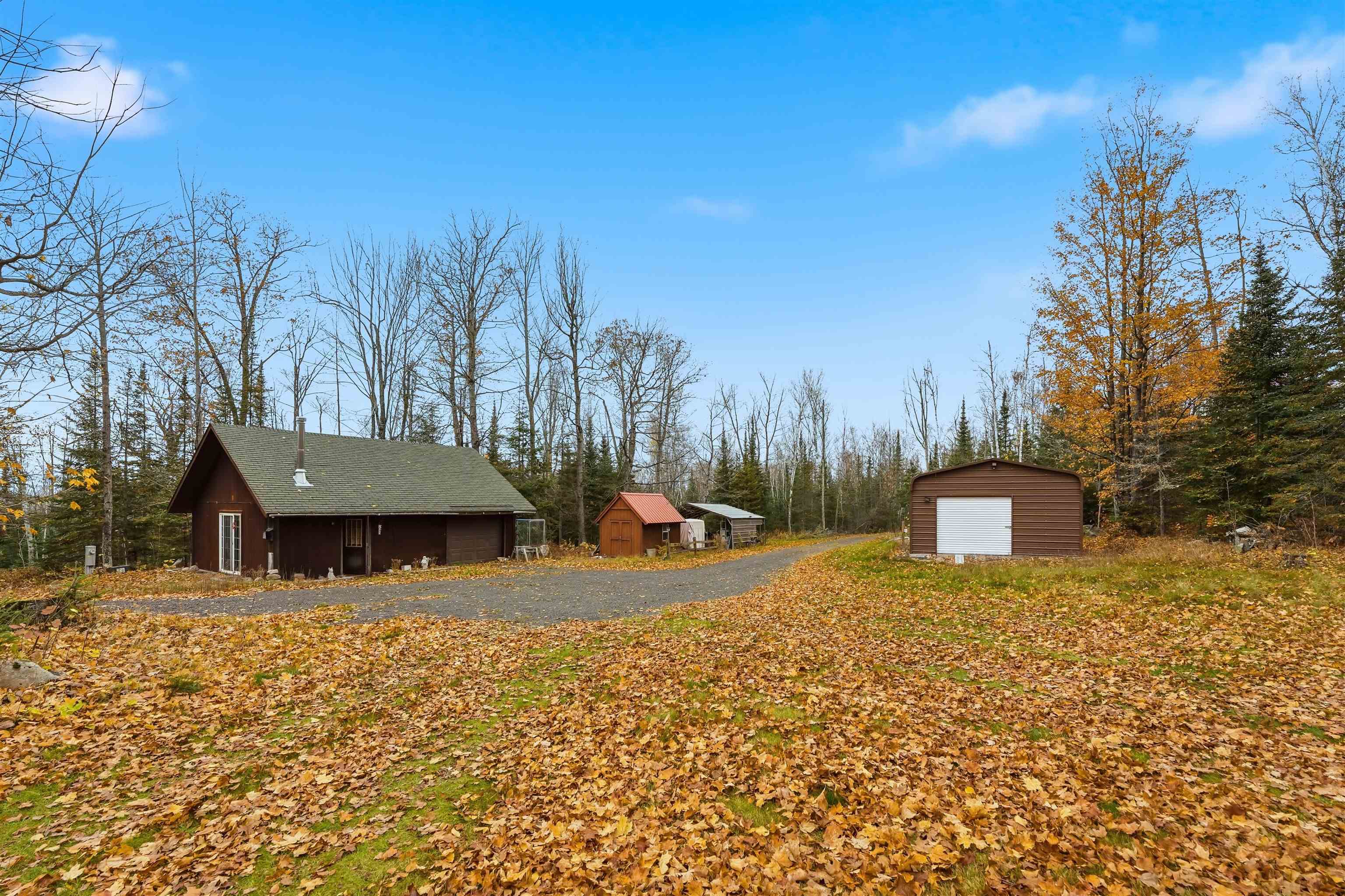 85255 Ravine Road Port Wing, WI 54865 - Photo 27 of 38 View of side of home featuring a garage and a storage shed