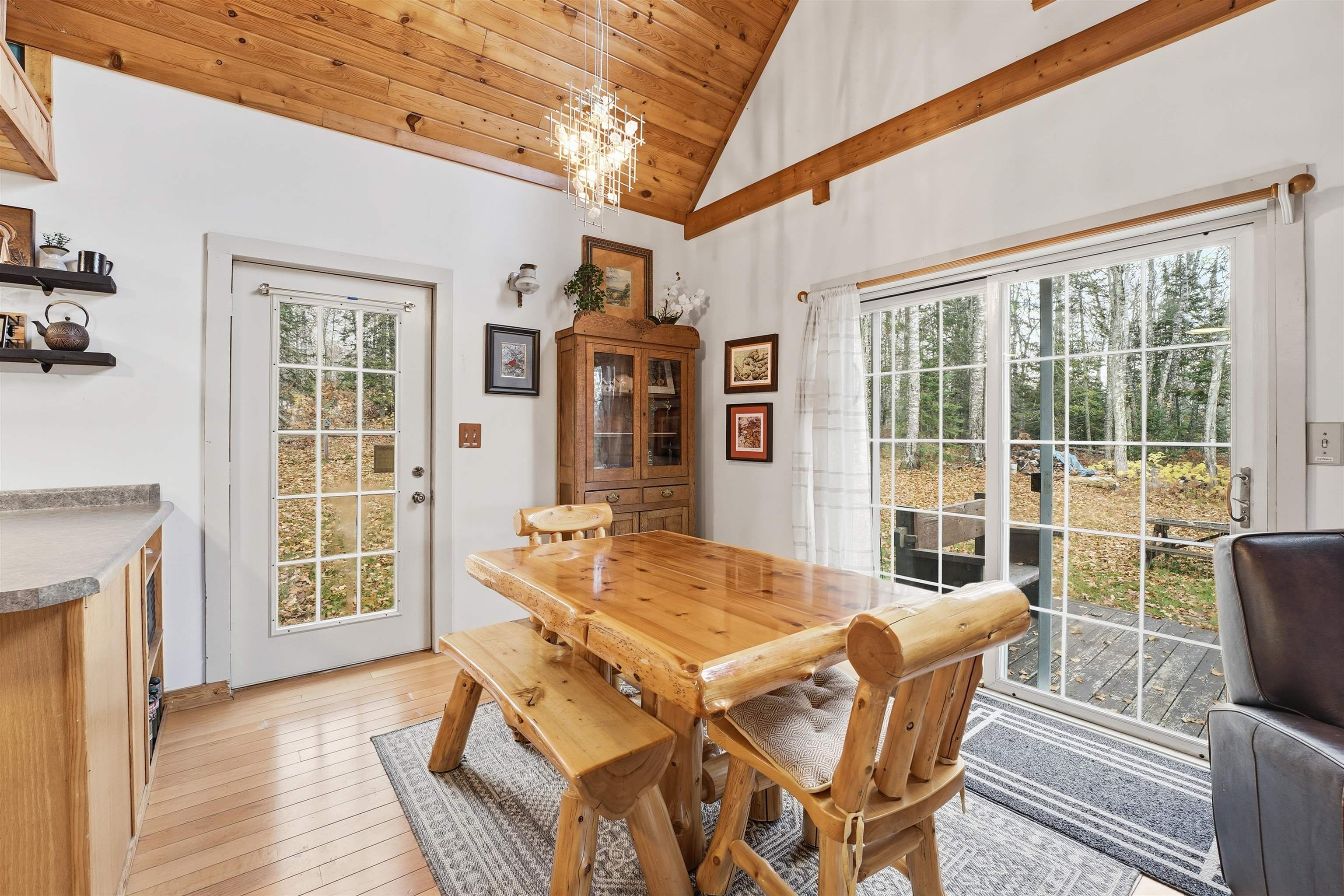 85255 Ravine Road Port Wing, WI 54865 - Photo 8 of 38 Dining area with light wood-style flooring, high vaulted ceiling, wooden ceiling, and a chandelier
