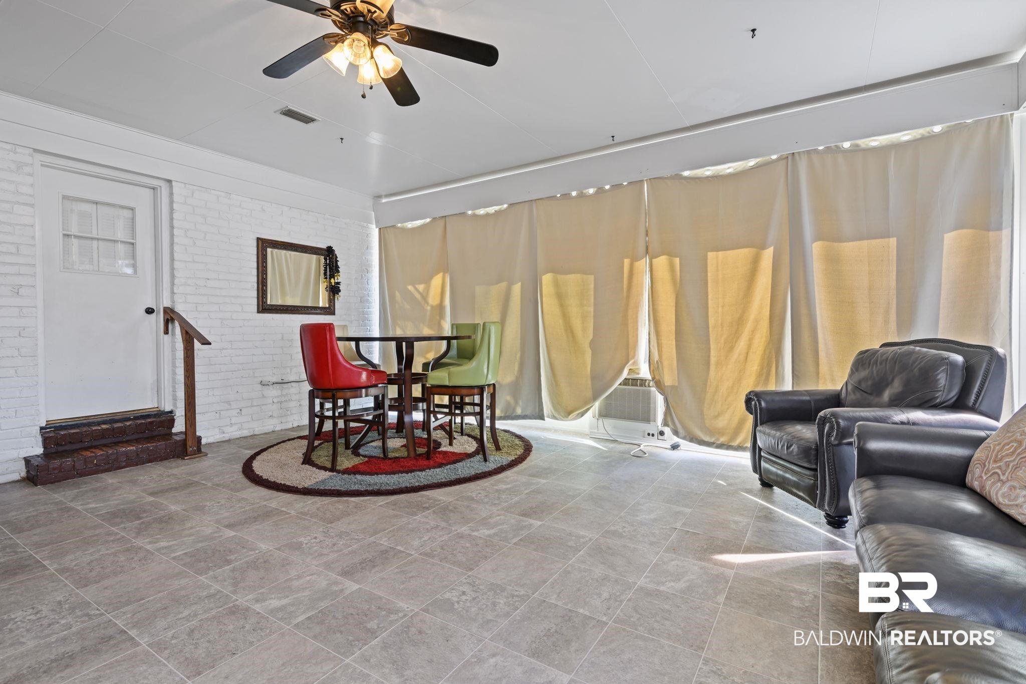 4105 Libby Drive Mobile, AL 36693 - Photo 19 of 26 Living room with ceiling fan and brick wall