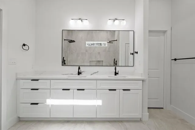 a bathroom with a double vanity sink mirror and double