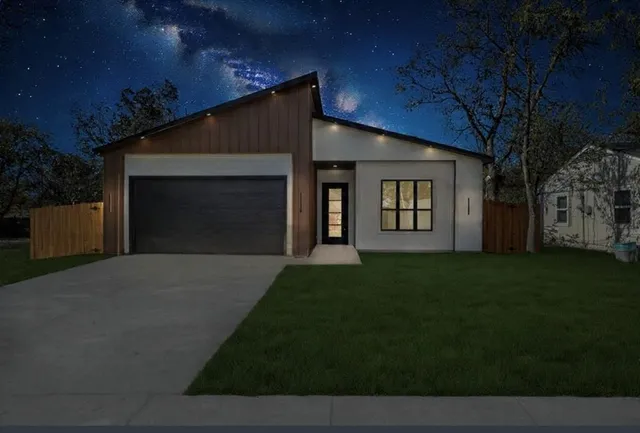 a view of a backyard with large trees and wooden fence