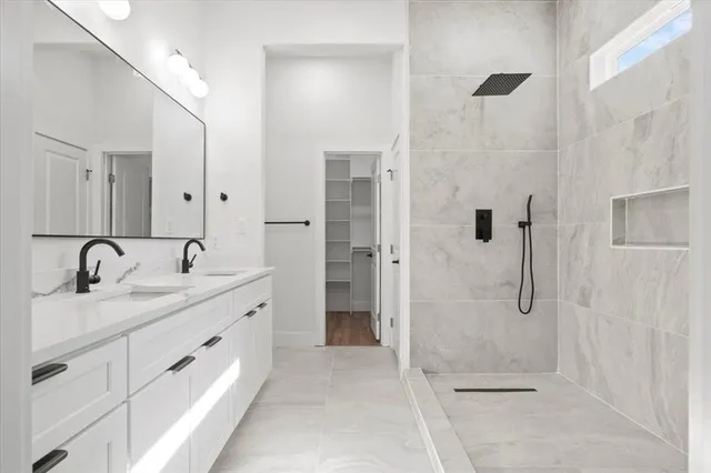 a spacious bathroom with a granite countertop sink mirror and shower