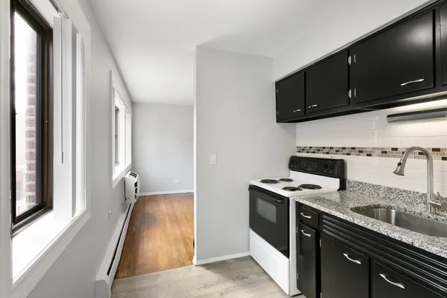 a kitchen with stainless steel appliances granite countertop a stove and a microwave