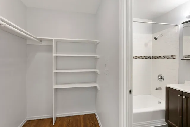 a view of walk in closet with empty racks