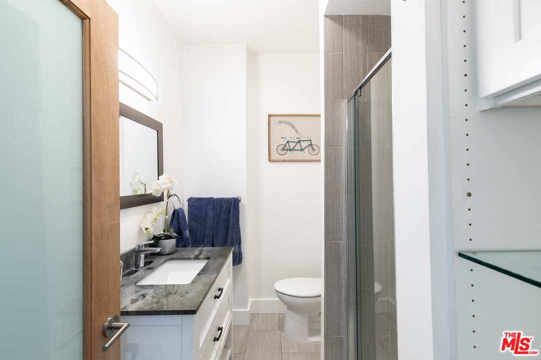 40 Westminster Avenue, Unit 8 Venice, CA 90291 - Photo 11 of 13 a bathroom with a granite countertop toilet sink and mirror