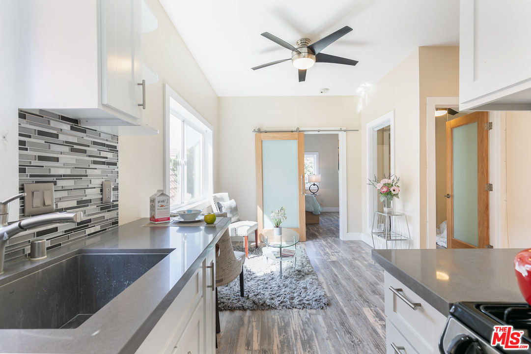 40 Westminster Avenue, Unit 8 Venice, CA 90291 - Photo 4 of 13 a living room with stainless steel appliances kitchen island granite countertop a sink dishwasher and a stove with wooden floor