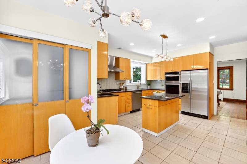 184 Old Short Hills Road Short Hills, NJ 07078 - Photo 20 of 46 a kitchen with stainless steel appliances kitchen island granite countertop a refrigerator a sink a oven with a dining table and chairs