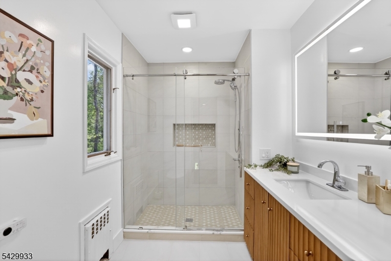 184 Old Short Hills Road Short Hills, NJ 07078 - Photo 32 of 46 a bathroom with a granite countertop sink a mirror a shower and a bathtub