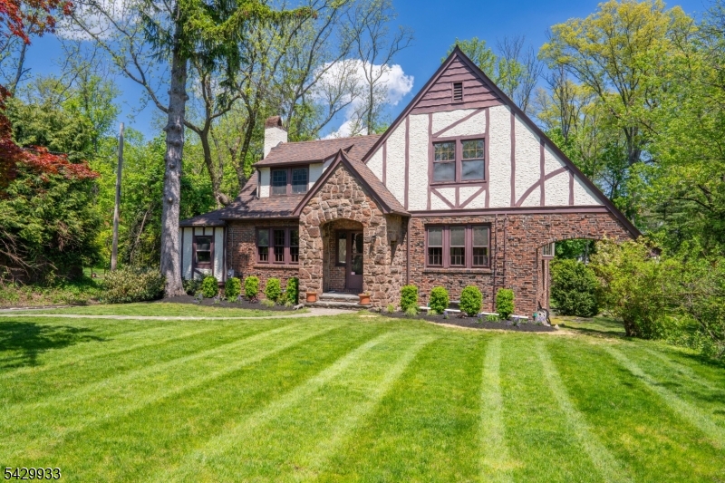184 Old Short Hills Road Short Hills, NJ 07078 - Photo 4 of 46 a front view of a house with a yard and trees
