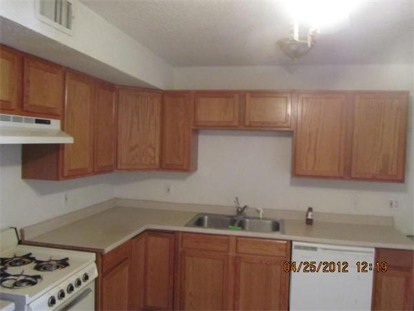 526 Third Street, Unit 2 Fall River, MA 02721 - Photo 6 of 15 a kitchen with stainless steel appliances a sink dishwasher stove and cabinets