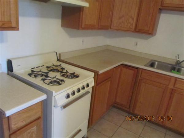 526 Third Street, Unit 2 Fall River, MA 02721 - Photo 7 of 15 a kitchen with a stove and a sink