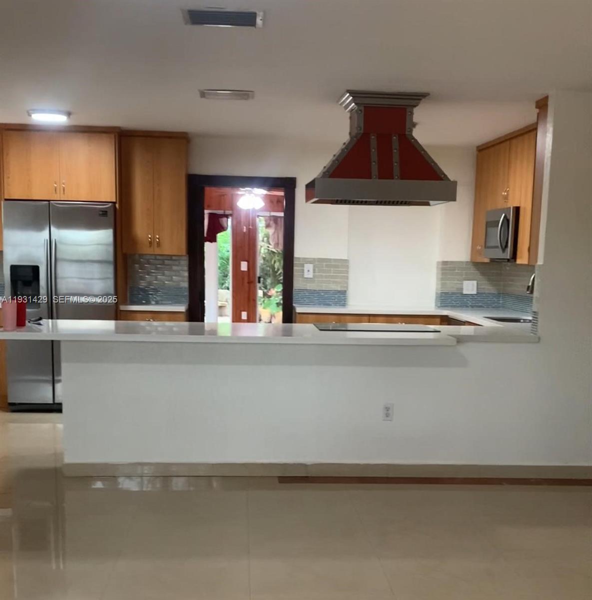 10955 Southwest 56th Street Miami, FL 33165 - Photo 2 of 39 a kitchen with a sink and a refrigerator