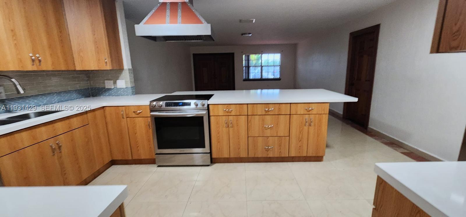 10955 Southwest 56th Street Miami, FL 33165 - Photo 3 of 39 a kitchen with a stove and a refrigerator