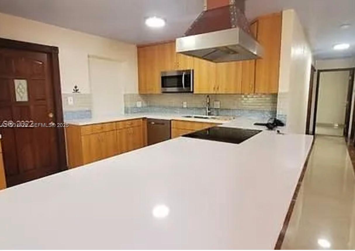 10955 Southwest 56th Street Miami, FL 33165 - Photo 4 of 39 a kitchen with a sink a stove and cabinets
