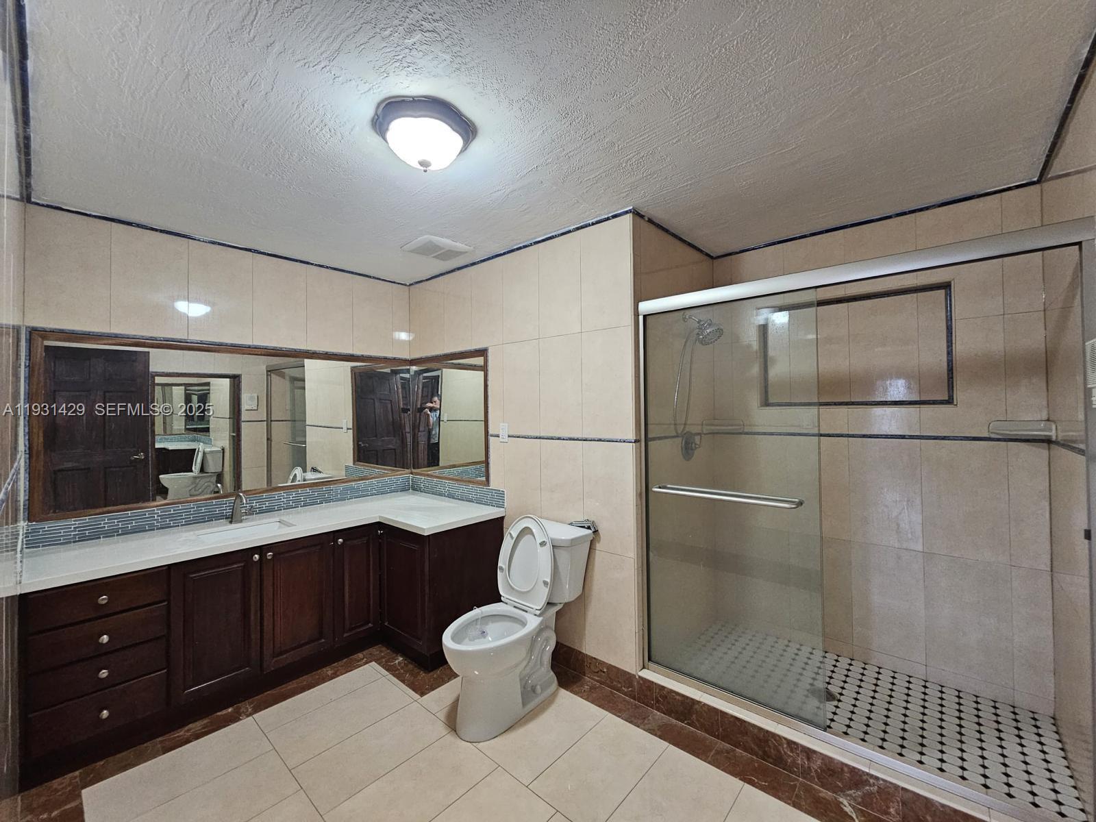 10955 Southwest 56th Street Miami, FL 33165 - Photo 5 of 39 a bathroom with a sink a toilet and shower