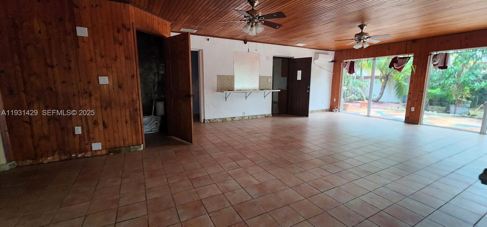 10955 Southwest 56th Street Miami, FL 33165 - Photo 6 of 39 a view of a porch with wooden floor and a chandelier
