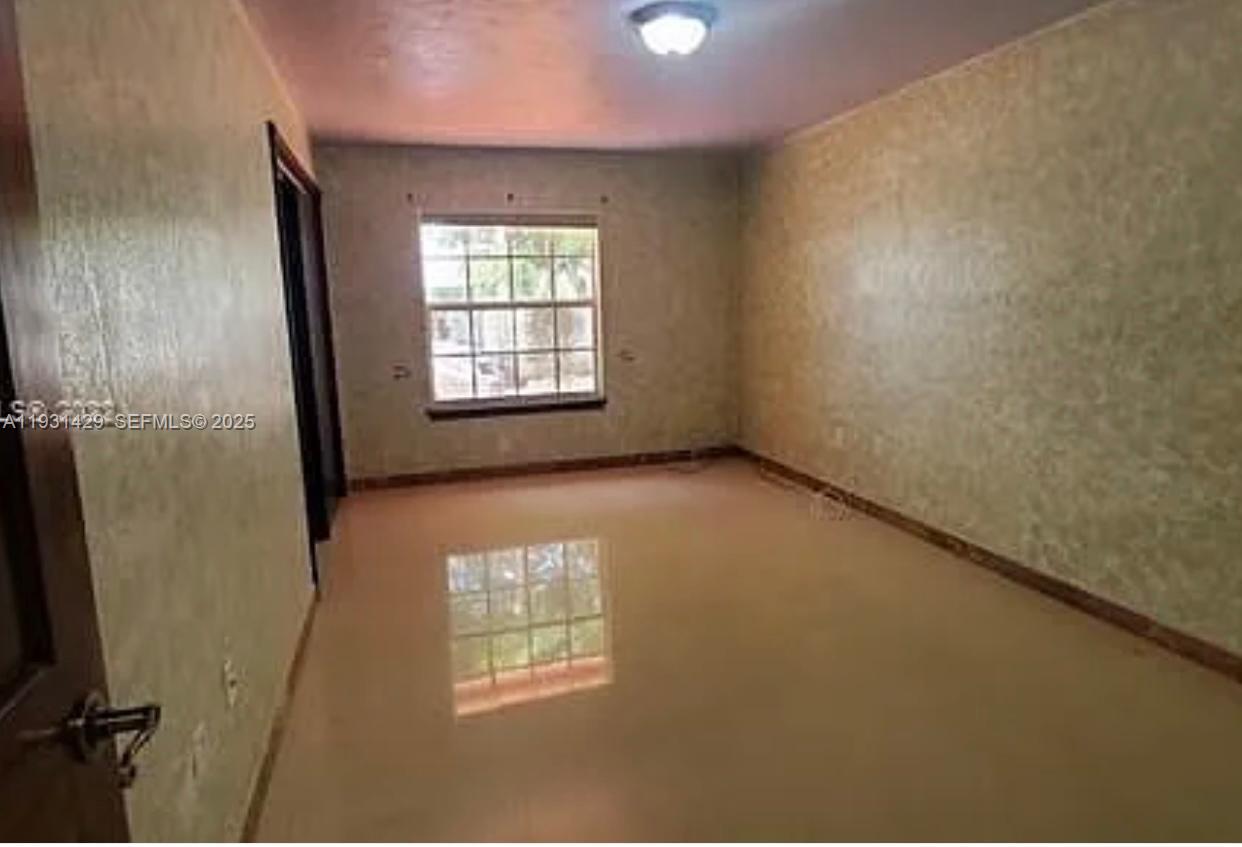 10955 Southwest 56th Street Miami, FL 33165 - Photo 7 of 39 an empty room with windows