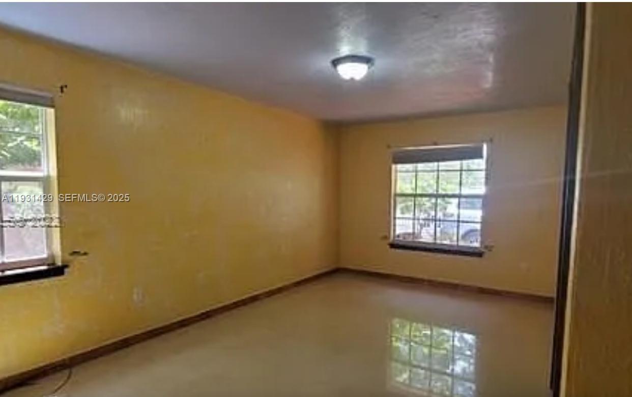 10955 Southwest 56th Street Miami, FL 33165 - Photo 8 of 39 a view of an empty room with a window