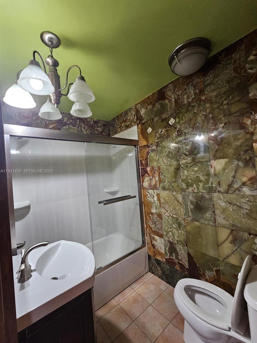 10955 Southwest 56th Street Miami, FL 33165 - Photo 10 of 39 a bathroom with a sink and a mirror