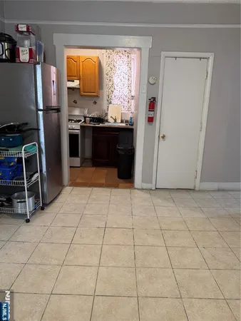 a kitchen with stainless steel appliances granite countertop a sink and a refrigerator