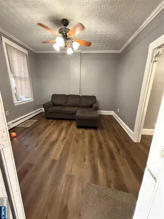 a living room with furniture and a hard wood floor